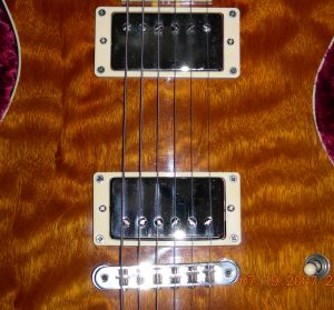 Notice how the stings align a bit differently over the tops of the humbucker pole pieces. 